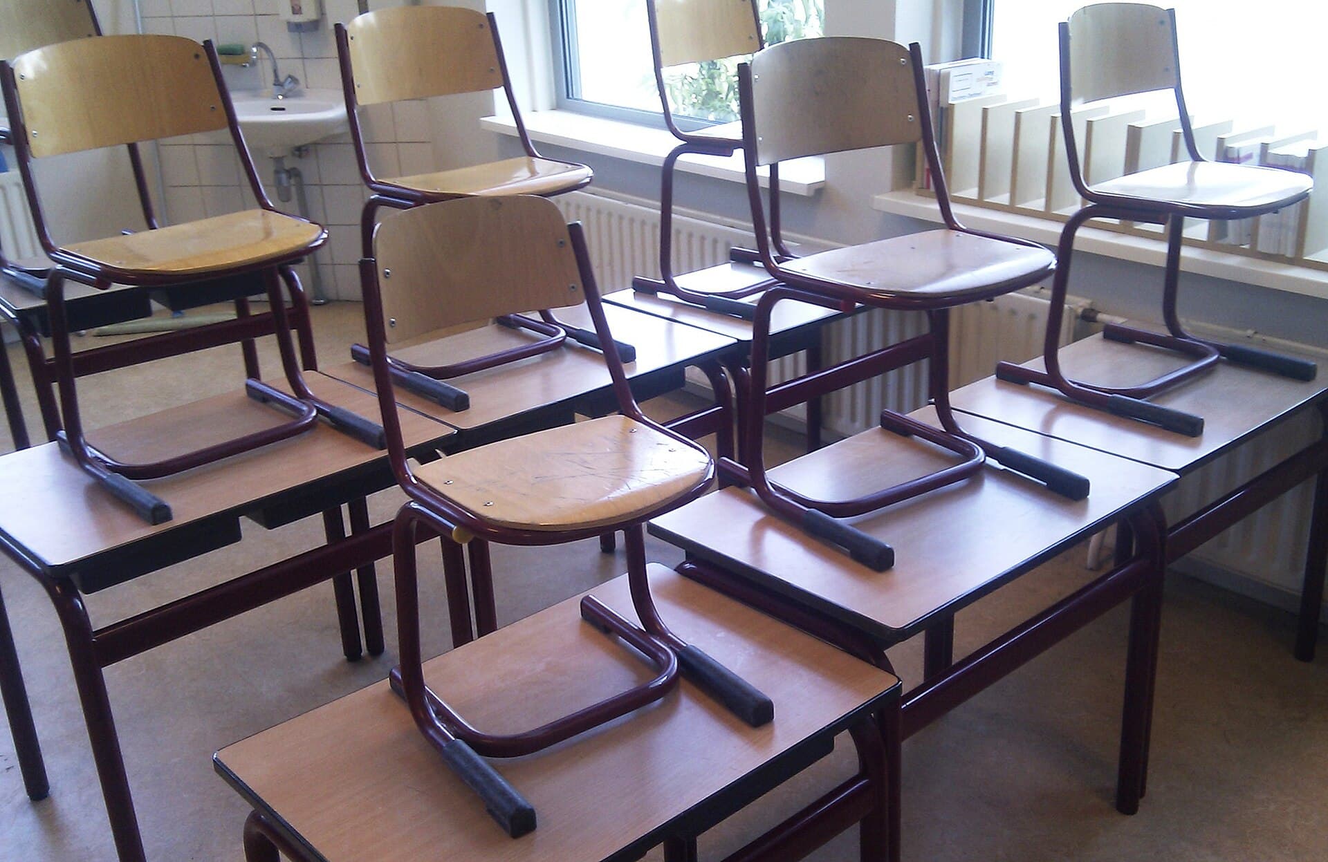 Empty school classroom with desks and chairs